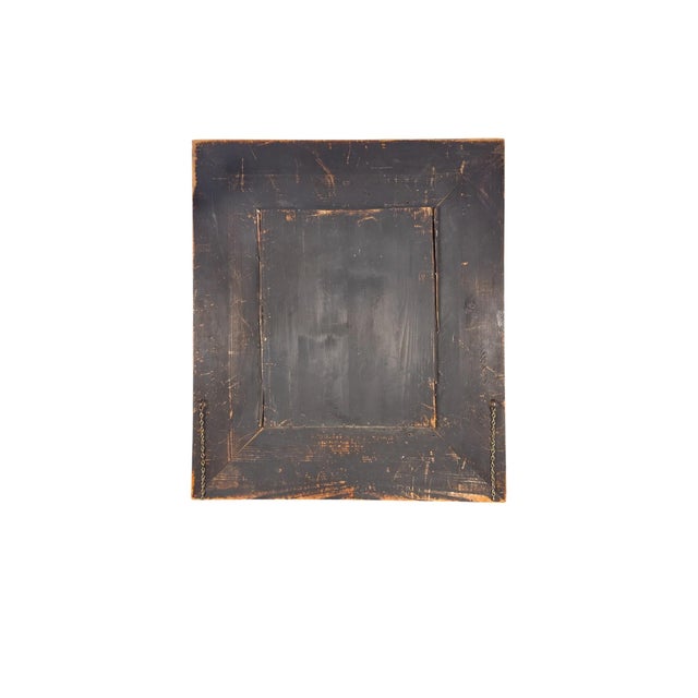 Elegant late 19th century French Napoleon III style wall mirror featuring an ebonized wood frame with finely detailed gilt...