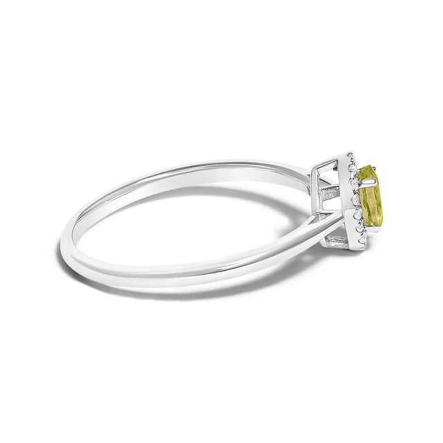 Contemporary 10K White Gold 5X3MM Oval Green Peridot and Diamond Accent Halo Ring (I-J Color, I1-I2 Clarity) - Ring Size 7 For Sale - Image 3 of 7
