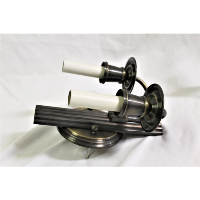 Set of three Modern/Deco sconces cast in Bronze and all Brass hardware . Two arms with 4" Candelabra sockets and covers....