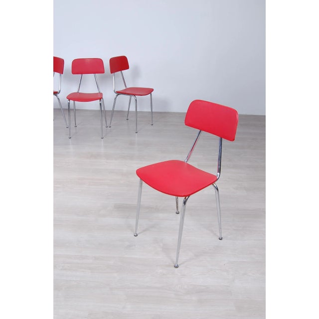 Set consists of four stackable chairs original design 50s, not a remake of the present day. Chromed steel frame, seat and...