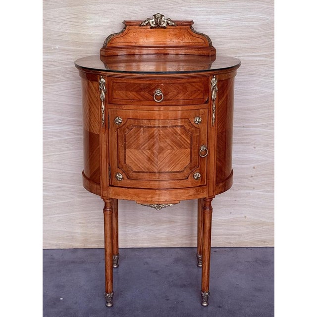 Louis XVI style pair of Marquetry nightstands with bronze crest one drawer and one compartment. Originals handles and...