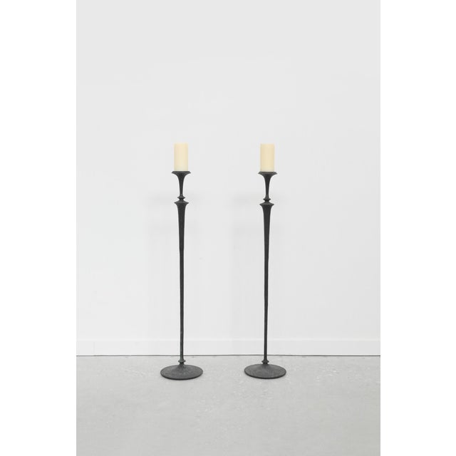 A pair of tall brutalist floor candleholders featuring a textured hammered finish. Perfect for dramatic floor lighting...