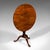 This is an antique tilt-top table. An English, mahogany occasional table with birdcage mount, dating to the Georgian...