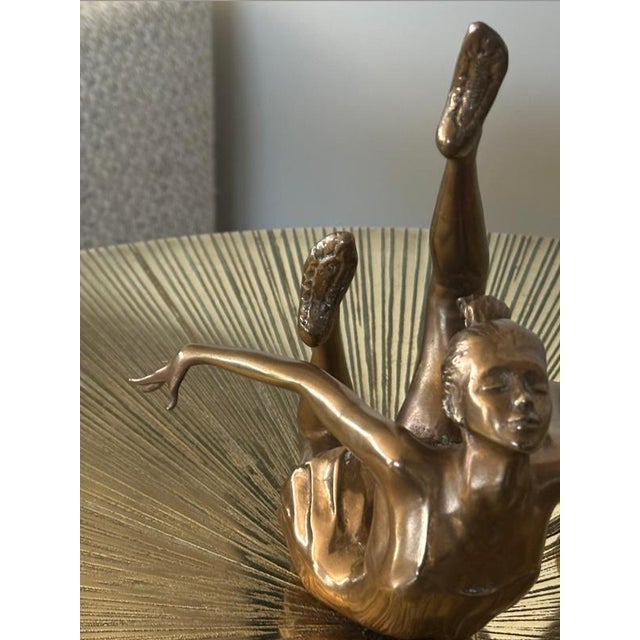 This small bronze figural sculpture by Eleanor Cardozo depicts a rhythmic gymnast with ball and was created in Switzerland...