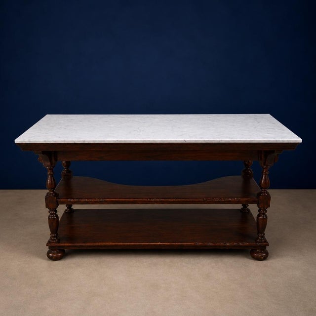 A refined blend of classic craftsmanship and timeless materials, this 20th Century English Walnut Base and Marble Top Bar...