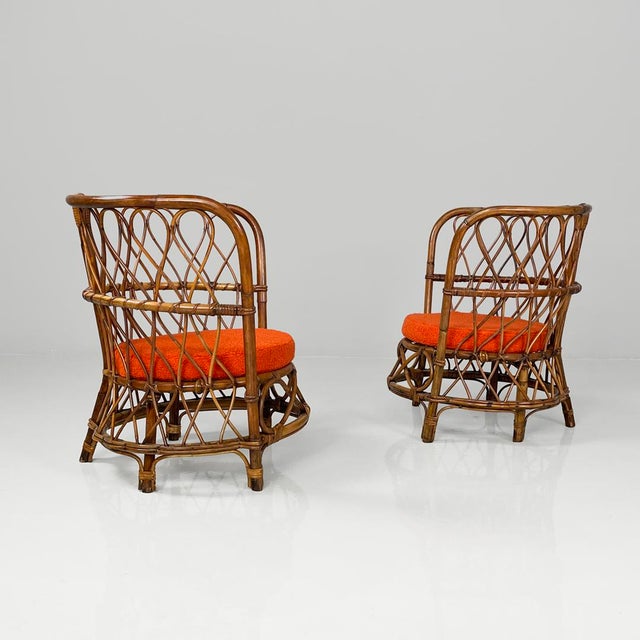Italian modern round seatings rattan cockpit armchairs with decorations, 1970s Pair of tub chairs entirely in rattan. The...