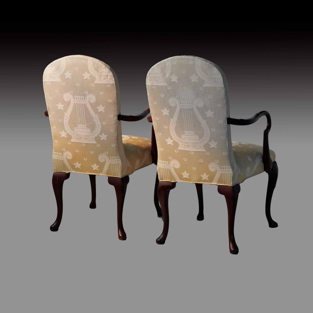 Pair of custom upholstered decorative vintage armchairs. Upholstery is a gently faded yellow with musical staff design...