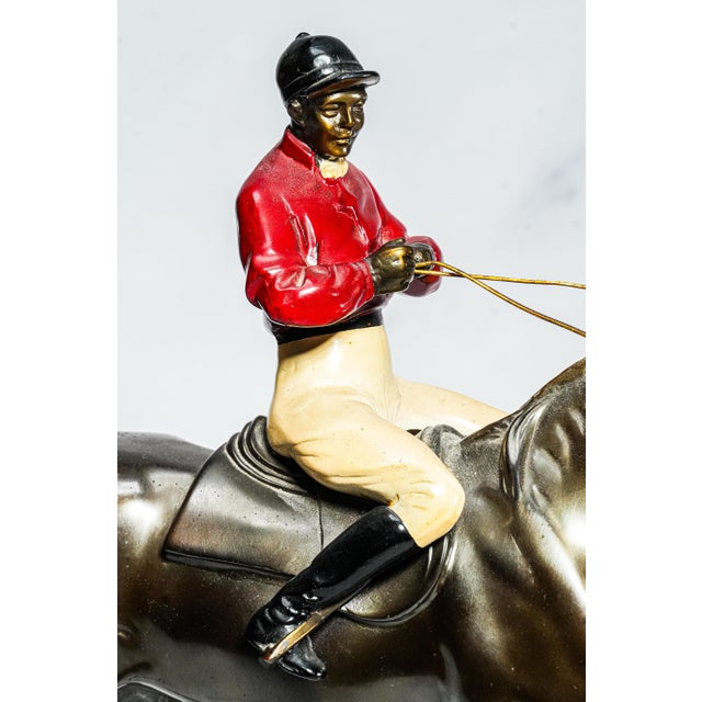 This striking antique equestrian sculpture, dating to circa 1930, captures the timeless elegance and athletic poise of a...