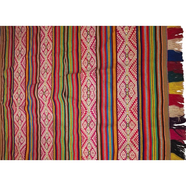 A remarkable antique Andean handwoven poncho, beautifully preserved and distinguished by its exceptionally vivid colors...