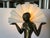 This striking Art Deco-style lamp showcases a beautifully sculptural nude figure of a woman inspired by Egyptian motifs,...