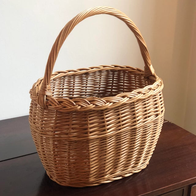 Offering a lovely vintage French-style market basket with a graceful oval shape, braided rim, French randing, and a warm,...