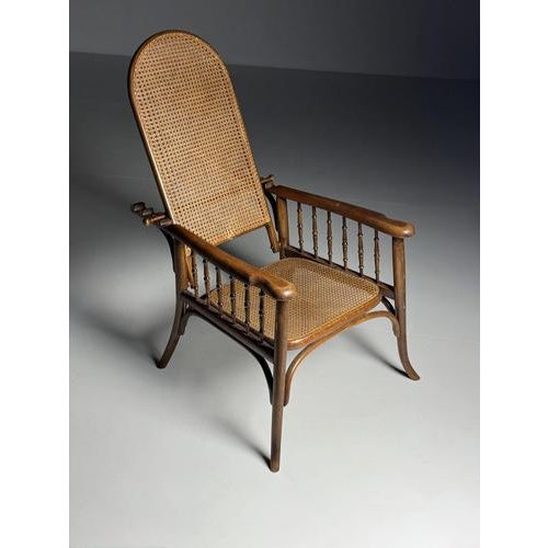 Thonet-style armchair. Made of bentwood. with a cane seat. In good condition! Adjustable back. Dimensions: 67W x 110H x 97H