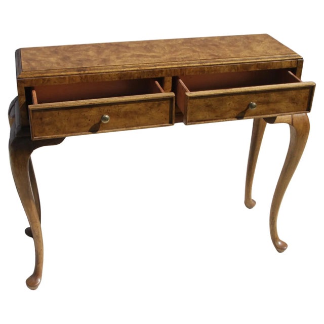 This is a burl writing table with Queen Anne styling. It has heavy brass hardware and is marked on the inside. It opens...
