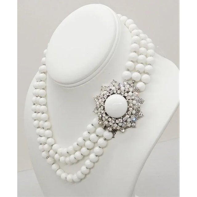 This is part of Chairish’s Costume Jewelry assortment. Early 1950s rhodium plated 3-strands of white beads with clasp of...