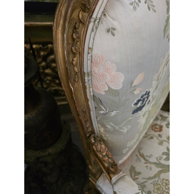 Stunning large scale giltwood Fauteuils with vintage Scalamande fabric and some exposed wood. These have beautiful carved...