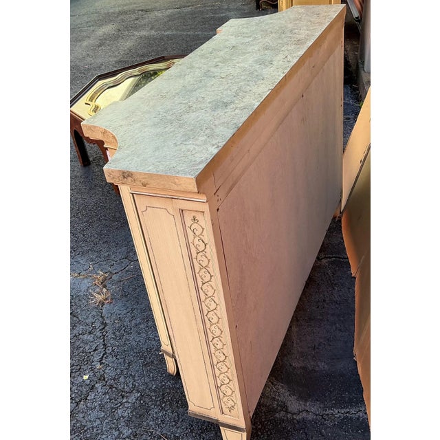 This is a hand painted Italian Neo-classical style cabinet with faux marble top. It also features a blush toned real...