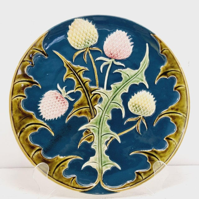 Art Nouveau majolica decorative wall plate with a relief thistle motif. Circa 1900. In excellent condition, with no...