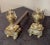 A Pair of Brass Andirons, of diminutive proportions Urn form, raised on scrolled base with Brass ball feet Tightened...