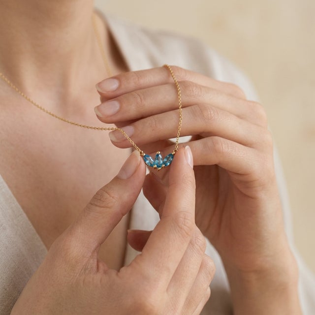 Add a touch of serene brilliance to your jewelry collection with this romantic three-stone pendant necklace, featuring...