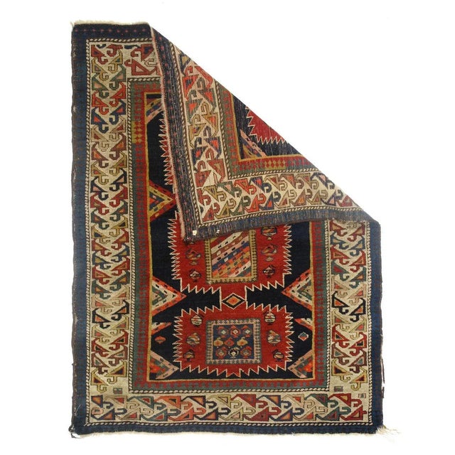 In a highly modified Karagashli "sunburst" design of a red pole medallion with three sharply serrated, unequal sized...