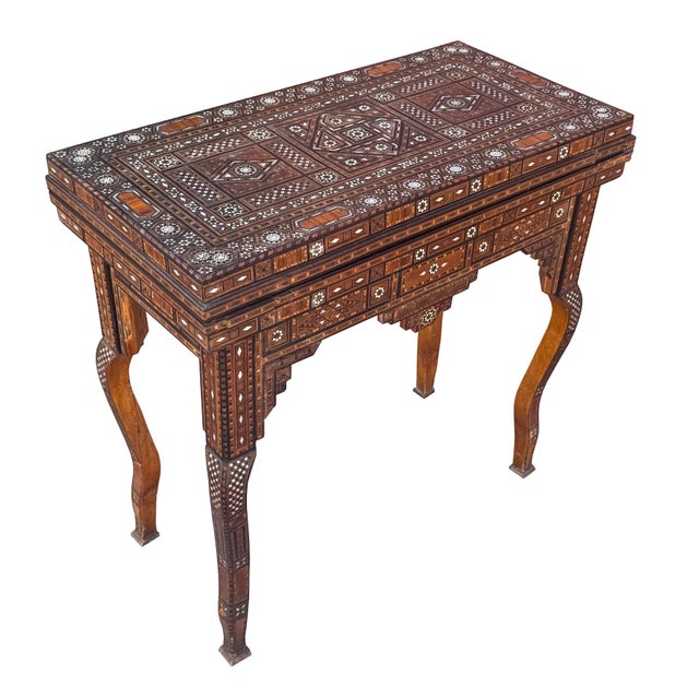 An exceptional antique Syrian folding game table showcasing the intricate craftsmanship of traditional Syrian marquetry....