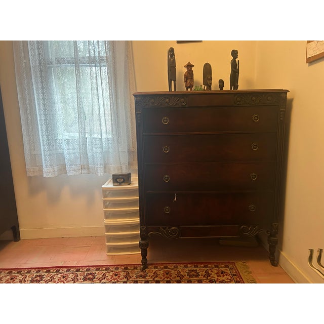 It features elaborate scrollwork (volutes) on the upper corners and the base apron.