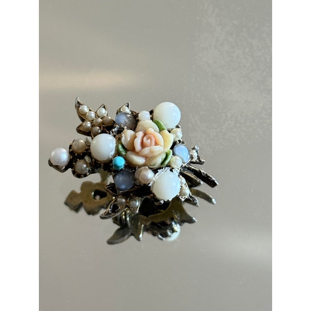Vintage 1950s floral costume jewelry brooch featuring a dimensional carved lucite rose surrounded by faux pearls and...