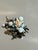 Vintage 1950s floral costume jewelry brooch featuring a dimensional carved lucite rose surrounded by faux pearls and...
