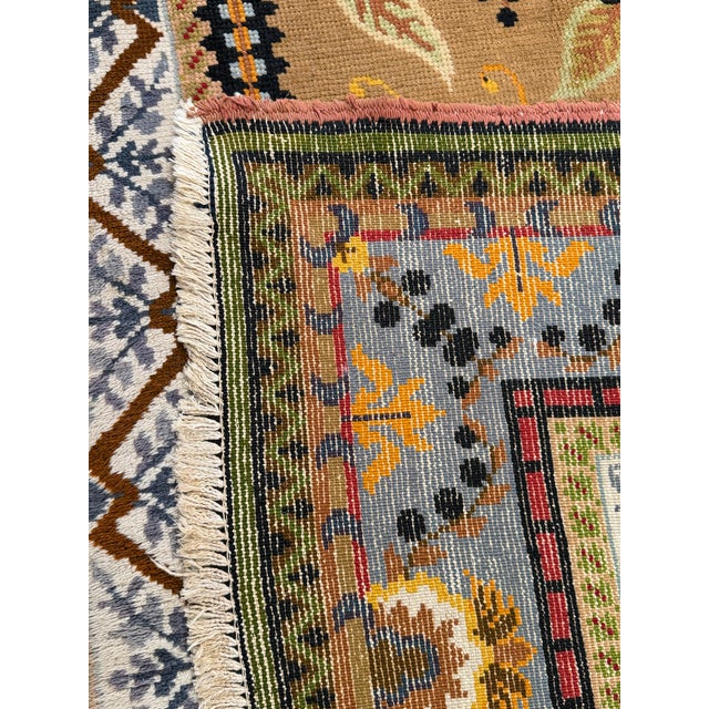 An oversized hand-knotted Oriental rug featuring an uncommon Art Nouveau-inspired floral design. The warm camel field is...