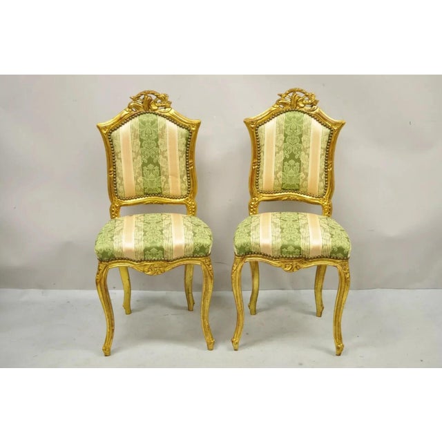 Vintage French Louis XV Style Gold Giltwood Carved Boudoir Side Chairs - a Pair. Item features a gold gilt finish, solid...