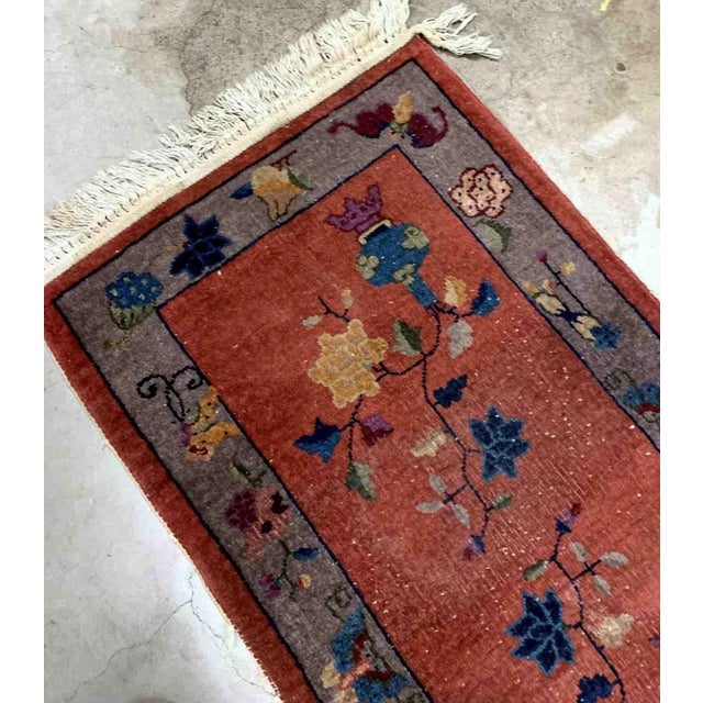 Handmade antique Art Deco Chinese rug in red shade with greyish border. The rug has traditional floral Art Deco design. It...