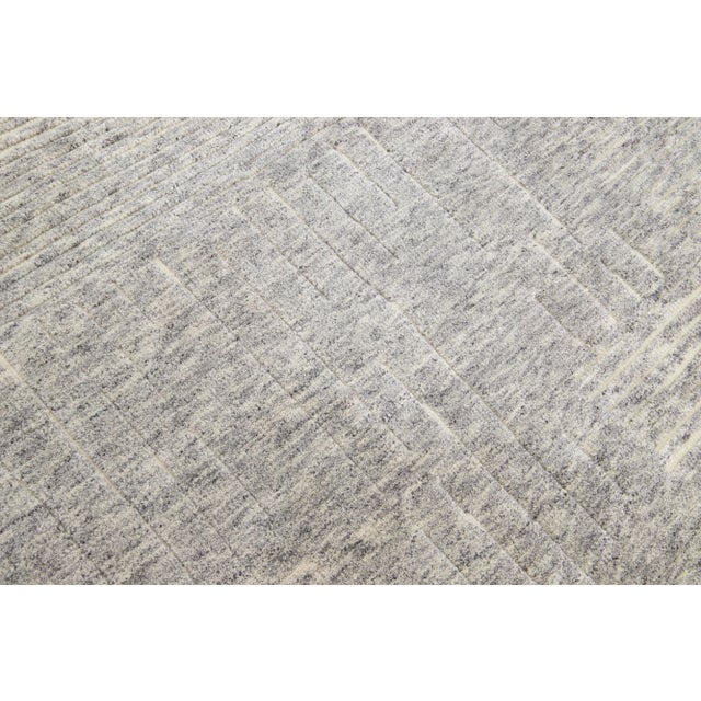 Beautiful modern Moroccan-style hand-knotted wool rug with a gray color field. This rug is part of our Apadana's Safi...