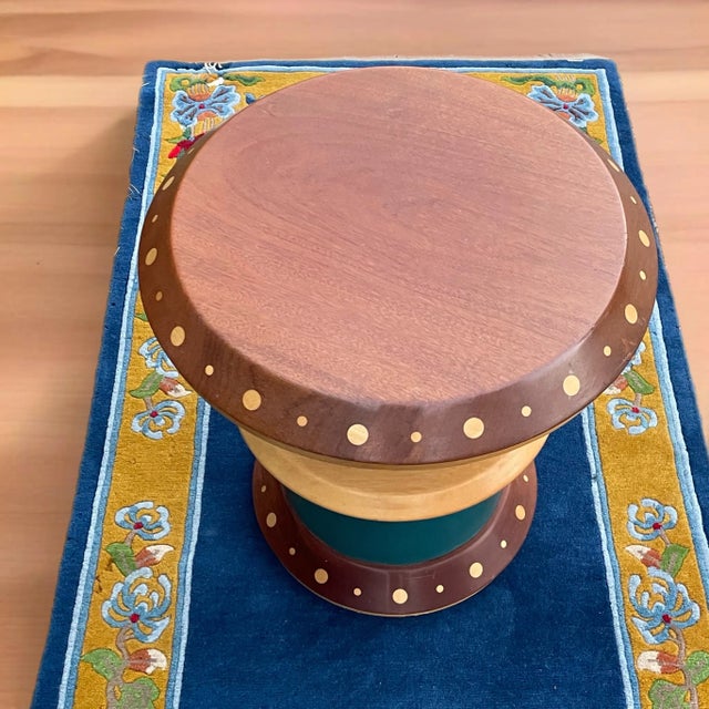 This stunning spool like table or garden stool is wrapped in a teal leather. It appears to be in a walnut and maple with...