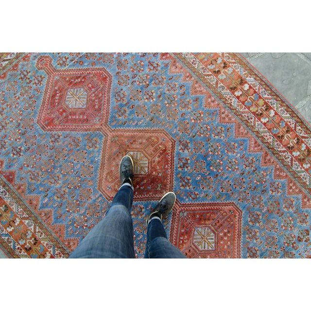 An antique rug with a wonderful geometric medallion design. Features colors such as blue for the base, along with rust...