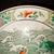 Gorgeous Chinese wucai porcelain display plate hand-painted with multiple colorful carp swimming amid rolling green ocean...