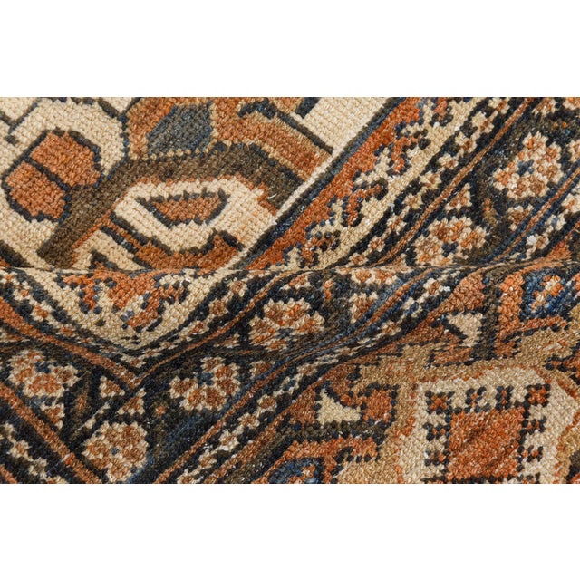 An early 20th century Persian Sultanabad antique rug, the cream field with palmette, abstract flowerhead and serrated leaf...