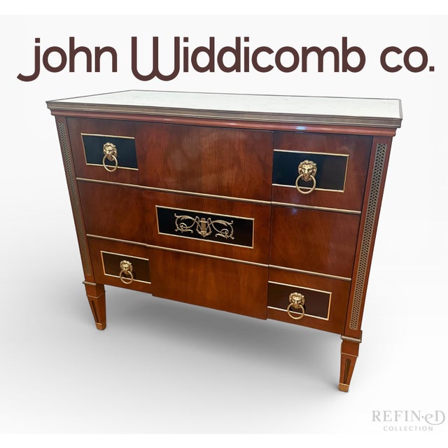 A distinguished 1981 John Widdicomb chest of drawers crafted in Grand Rapids, Michigan. This neoclassical-inspired design...