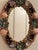 Charming vintage oval mirror featuring an intricately hand-applied collection of natural seashells in soft coastal hues....