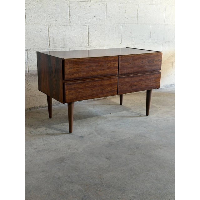 Beautiful vintage Danish Modern 4-drawer dresser crafted in richly grained rosewood, made in Denmark. This elegant Mid...