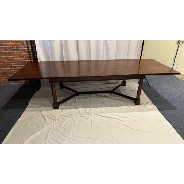 A large dining table with two large leaves in a farmhouse style. The stretcher keeps the table stable. The four legs screw...