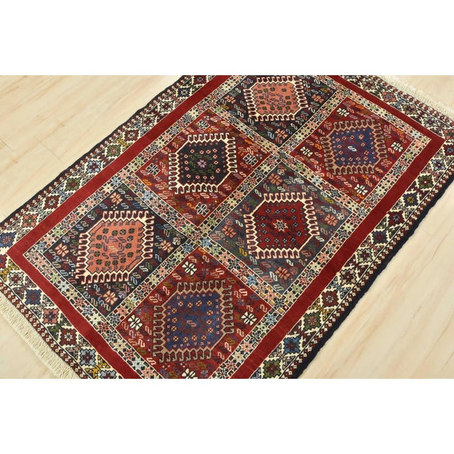 An authentic vintage tribal Yalameh rug hand-knotted with fine wool and natural dyes. This finely woven nomadic rug...