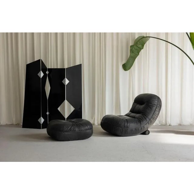 The amazing Tumble lounge chair and ottoman, designed by Adriano Piazzesi and manufactured by Tre D in Italy in 1973, is a...
