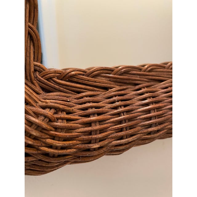 A vintage 1970s rattan small wall mirror with a thick, hand-woven basket weave frame. This is the kind of piece that works...