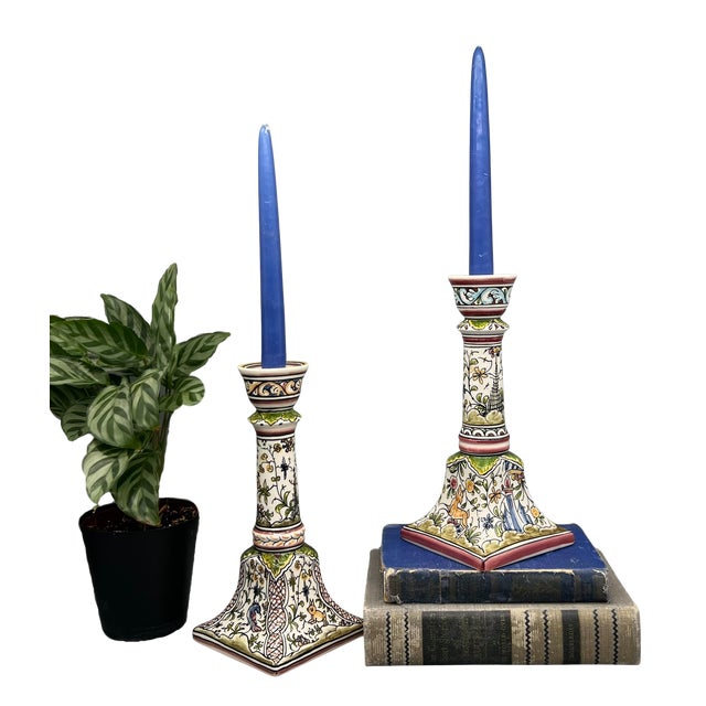 A charming pair of hand-painted Portuguese ceramic candlesticks decorated in a whimsical woodland motif with birds, dog,...
