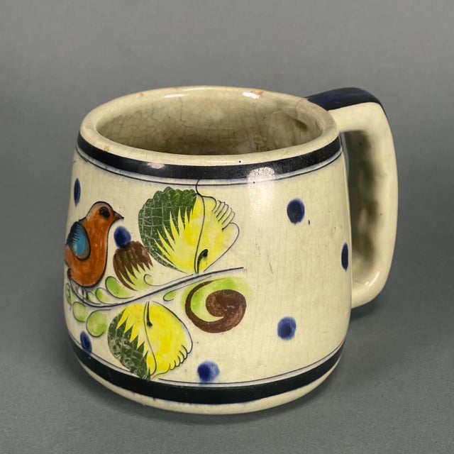 Estate sale find! Beautifully preserved hand-painted Tonala coffee mug with birds and flowers. The yellow and cobalt glaze...