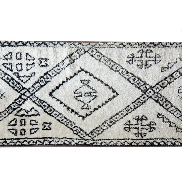 A gorgeous mid-20th century Moroccan rug woven in white and brown wool, and with a bold modern pattern containing large...