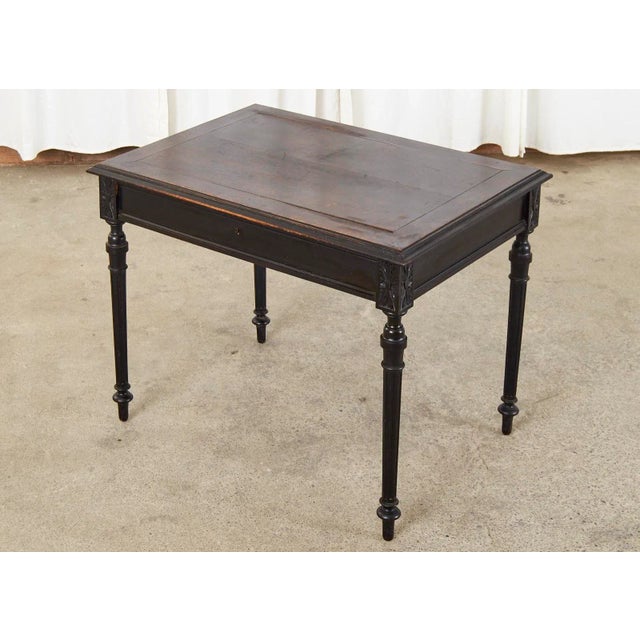 Dramatic French diminutive ladies writing table or desk featuring a black lacquer ebonized finish. Made in the...