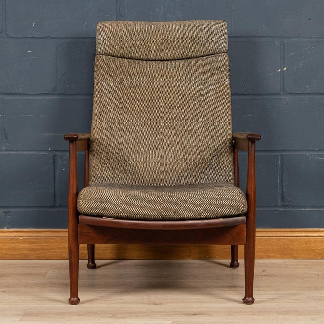 A mid century 'Manhattan' reclining armchair by Guy Rogers c1960's. A solid teak afromosia frame with a high backrest...