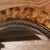 Vintage beveled glass wall mirror with a wide wooden frame with a tortoise shell painted finish and lined with a twist...