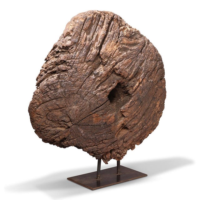 This sculptural piece captures authentic character through a reclaimed wooden cart wheel from Rajasthan, India, mounted on...